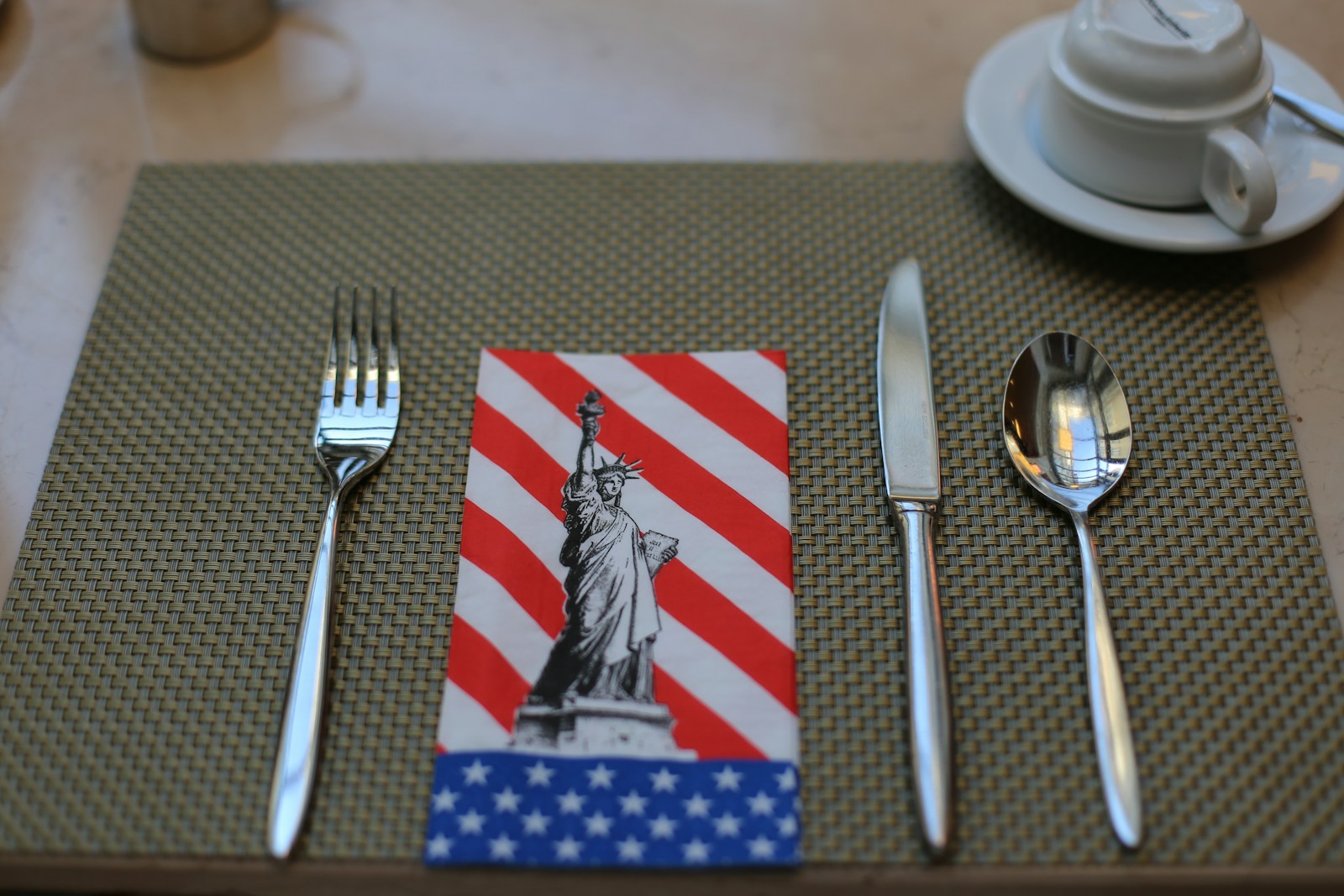 silver fork and bread knife on white ceramic plate